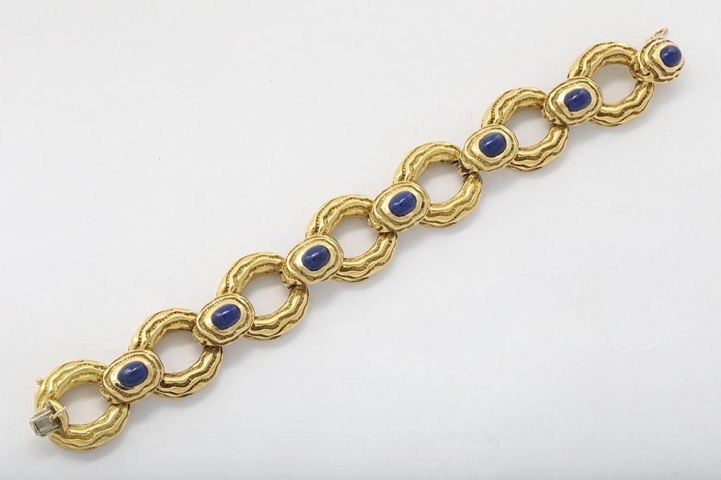 Tiffany & Co. 18KT gold bracelet set with lapis cabochons, highly textured links in a  modernistic style. Measures 6 3/4 inches. Tiffany mark, and gold mark.