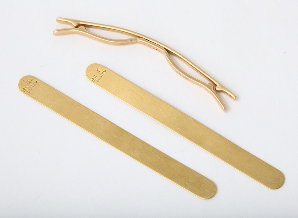 A Cartier 14KT gold collar clip made by Larter of Newark NJ, AND a pair of Cartier 18KT gold collar stays, 2 3/4 inches long. All 3 items marked Cartier; stays also have the Larter mark as manufacturer.