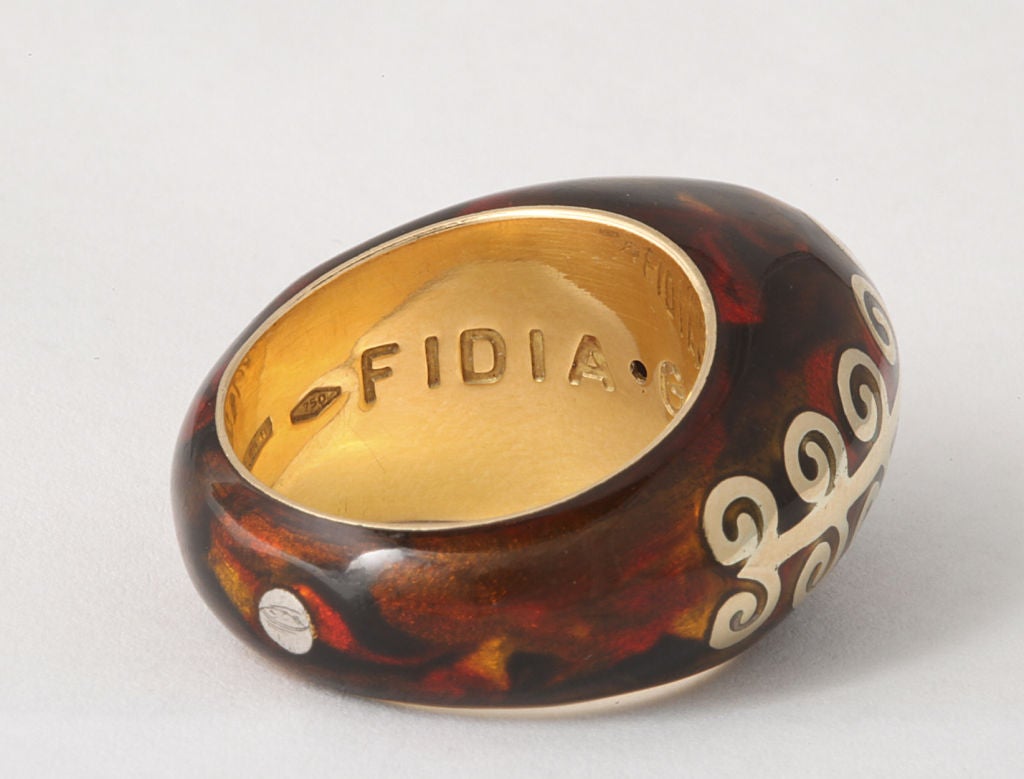 Exceptional 18K gold dome ring by Fidia Gioielli with brilliant faux tortoise effect in mottled red-brown enamels highlighting a repeated scroll detail carved above the ring's surface. Gioielli mark and gold mark. Size 7.