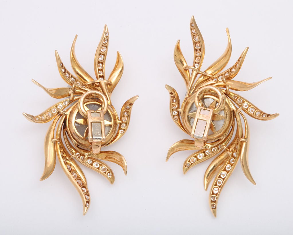 Spritzer and Fuhrmann, handmade 18K gold earclips featuring large mabe pearls surrounded by exotic diamond set florishes. 2 1/2 inches.