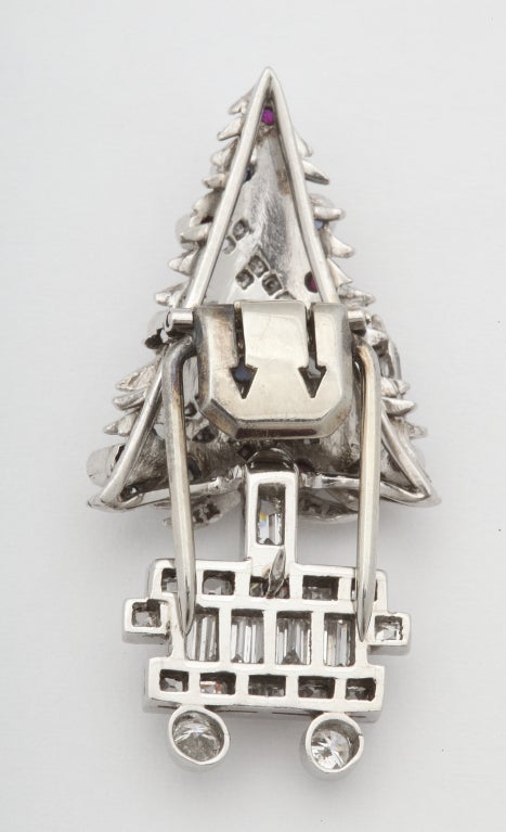 JUST IN TIME! - The perfect potted Christmas tree clip/brooch, of platinum, the branches set with diamonds, hung with ruby and sapphire ornaments, and baguette diamond candles. 1 1/2 in. Unmarked