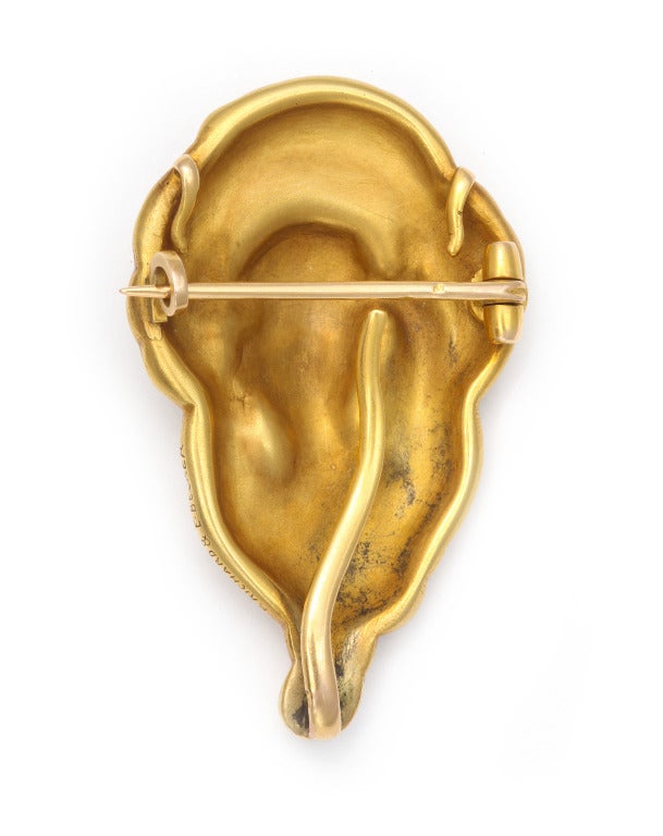 An Art Nouveau 18K gold brooch/watch holder/necklace pendant, depicting female and peacock forms, with removable pin back, hooks for chain, hook for lapel watch or jewel. Gold marks and signed Richard & Becker. 1 1/8 in. x 1 7/8 in.