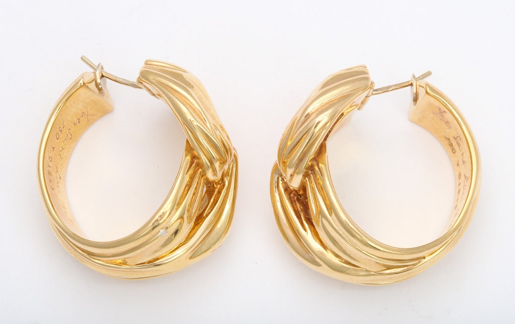 An elegant pair of 18K gold Yves Saint Laurent fabric inspired earrings - YSL jewelery is rarely seen in gold - these beautifully sculpted hoops typify the classic design esthetic of the legendary couture house. Light enough to wear all day and into