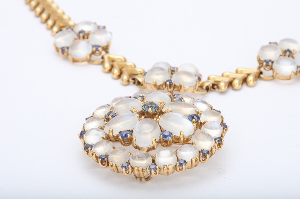 Beautiful 1900s convertible necklace by Newark jewelry maker Wordley, Allsopp & Bliss, of 14K gold holding 33 brilliant moonstones, complimented by 38 lively cornflower blue sapphires. 3 options for wear: Pendant removes, leaving a  necklace of