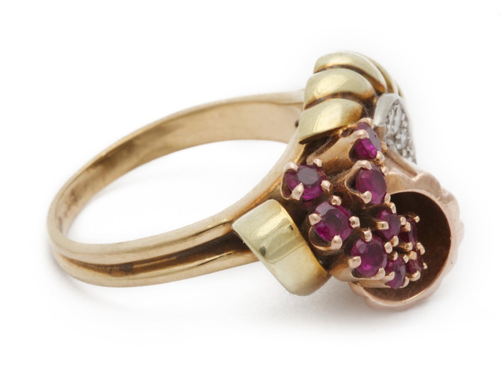 In time for the holiday! - A  very sweet 1940s tri-color 14K gold ring, as a 3-dimensional cornucopia spilling rubies, with diamond accents. Currently size 8 1/4, and can be easily sized up or down for you.