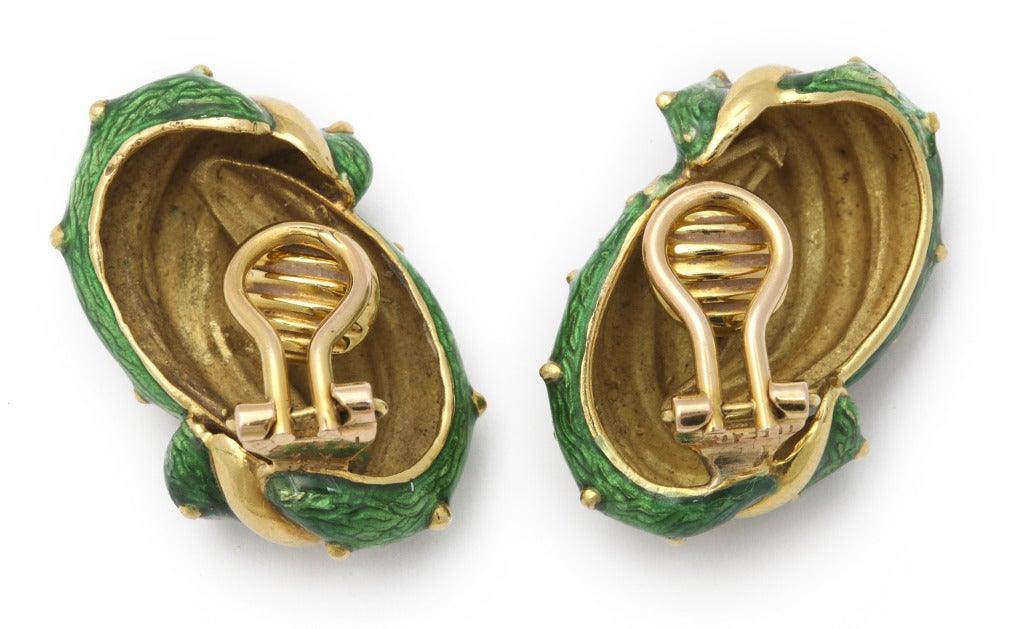 A 1960's Donald Claflin design for Tiffany ear clips - as intertwined leaves in 18K gold with hand engraved surface detail under translucent green enamel. Tiffany mark, gold mark, and Italian maker marks. 1.5 x .75 inches. 18.5 pennyweights of gold.