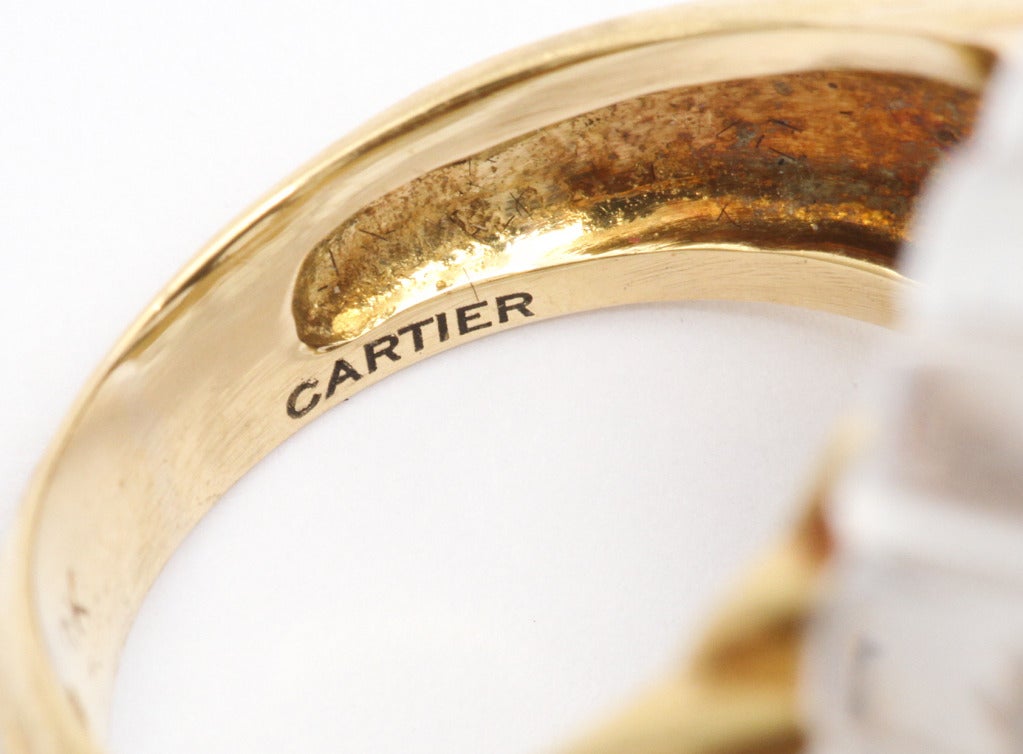Elegant 1973 Cartier Art Deco style ear clips and matching ring, of carved rock crystal set on 18K gold, with exagerated cabochons of black jade, each  surrounded by a ring of diamonds. Cartier and gold marks. Ring fits size 5 3/4 - 6.