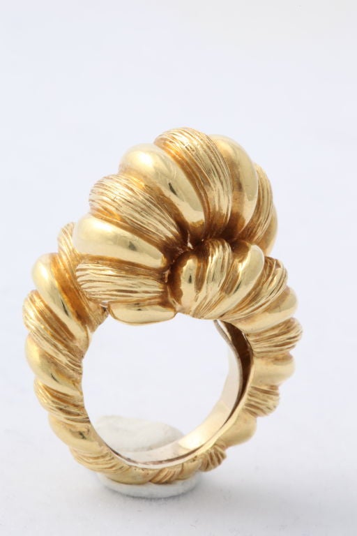 Extravagant Cartier 18KT gold ring as a wide knot of textured rope standing 3/4 inch above the finger. Cartier mark. Size 71/2, with built in size reducing ring.