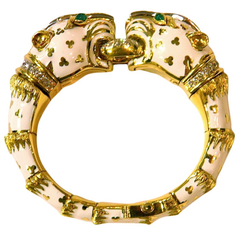David Webb original and early version of the white tiger bracelet in 18KT yellow gold and platinum, with white enamel, set with diamonds and cabochon emeralds. Marked David Webb.