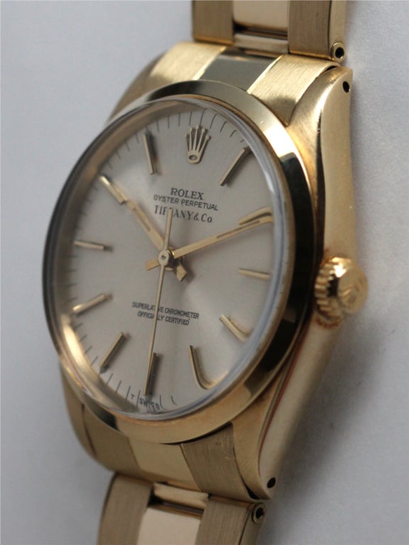 Rolex 14K yellow gold Oyster Perpetual wristwatch Ref 1002, serial 3.5 million, circa 1973, 34mm diameter case with smooth bezel, with original Tiffany & Co silvered satin dial with gold applied indexes and gold baton hands. Cal. 1570 automatic