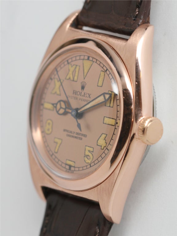 Rolex 18k pink gold bubbleback top, stainless steel back tropical model circa 1940s. Featuring solid rose gold bezel and case, with stainless steel Ref. 3696 caseback circa 1940s. With beautiful salmon dial with luminous 1/2 Roman and 1/2 Arabic