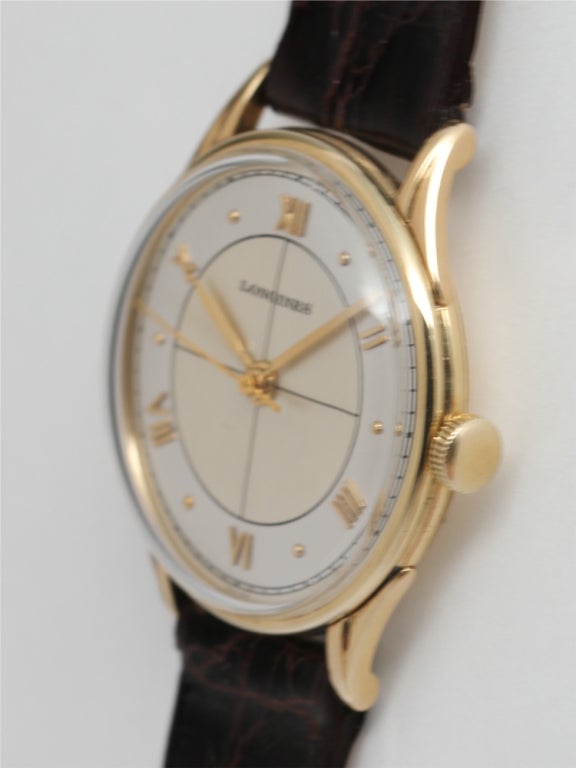 Longines 14k yellow gold wristwatch, circa 1947. 32mm diameter case with curved, fluted lugs and beautifully restored two-tone silvered dial with gold applied indexes, cross-hairs pattern, and gold baton hands. 17 jewel manual wind movement with