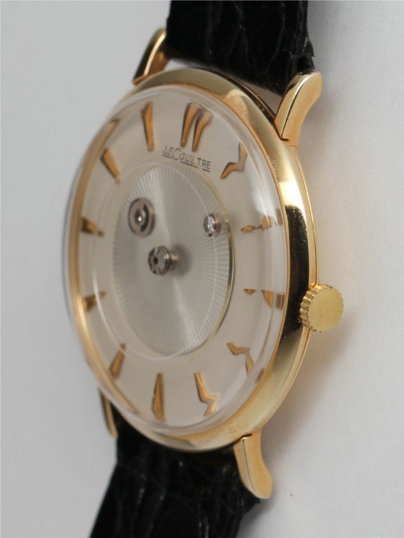 Jaeger-LeCoultre 14k yellow gold mystery dial wristwatch, circa 1960s. 32mm case with original dial featuring applied gold dagger indexes and rotating center disk with hour and minute indicators. 17-jewel manual-wind movement. Clean, popular vintage