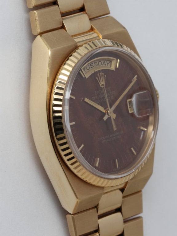 Rolex 18k yellow gold Oysterquartz Day Date Presidential wristwatch, Ref 19018, circa 1980. 36mm diameter uniquely designed geometric shaped case with fluted bezel and scarce original burlwood dial signed Rolex Oyster Quartz Day Date. Rolex in-house