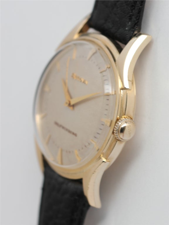 Bulova 14k yellow gold automatic wristwatch, circa 1955. Very unusual and great looking model with bombe shaped 34 X 41mm case with curved lugs and screw down caseback. Beautiful condition original silvered satin dial with gold indexes and tapered