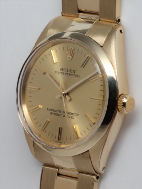 Rolex 14k yellow gold Oyster Perpetual, Ref. 1005, serial 1.8 million, circa 1967. 34mm diameter case with smooth bezel, acrylic crystal, and beautiful condition original champagne dial with gold applied indexes and gold baton hands. Self-winding