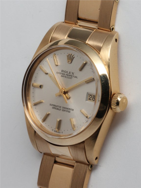 Rolex 18k yellow gold Oyster Perpetual Datejust Midsize, Ref. 6827, 31mm diameter case with smooth bezel, serial number 6.4 million, circa 1980, with original silvered satin dial with gold applied indexes and matching gold hands. Self-winding