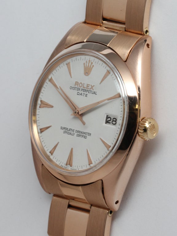 Rolex 18k pink gold Oyster Perpetual Date wristwatch, Ref. 1503, serial number 903,XXX, circa 1962. 34mm diameter case with smooth bezel and very pleasing antique white dial with raised triangular indexes and tapered dauphine hands. Powered by