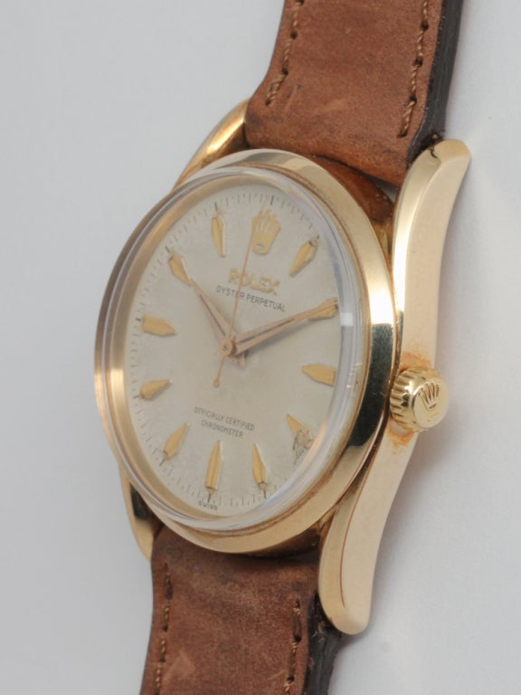 Rolex 14k yellow gold Oyster Perpetual Bombe wristwatch, circa 1950s. 35mm diameter case with smooth bezel and curved lugs with nicely patinaed original dial with eccentric gold indexes and tapered dauphine hands. Calibre 1030 self-winding movement