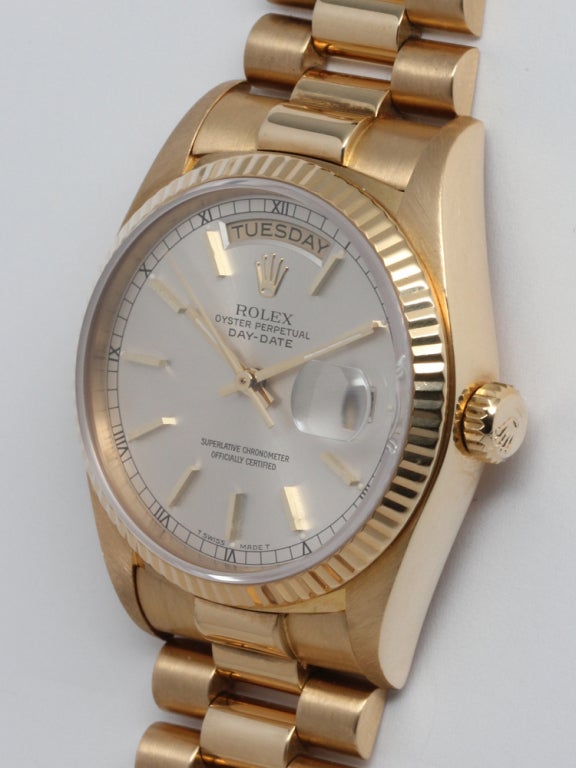 Rolex 18k yellow gold Day-Date President wristwatch, Ref. 18038, serial 6.5 million, circa 1981. 36mm diameter case with fluted bezel, sapphire crystal, quick set date, calibre 3055 movement, and classic silvered satin dial with gold applied indexes
