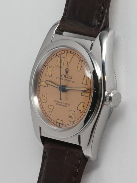 Rolex stainless steel Bubbleback wristwatch, Ref. 2940. 31 x 38mm tonneau-shaped case with smooth bezel, circa 1940s, with beautifully restored salmon dial with patinaed luminous indexes and matching Mercedes hands. Calibre NA self-winding movement