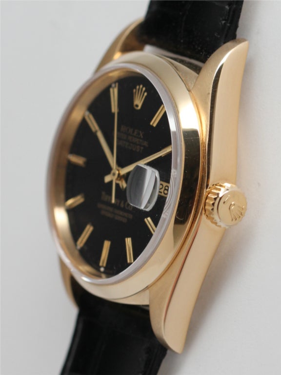Rolex 18k yellow gold Datejust, Ref. 16238, serial E8, circa 1990, retailed by Tiffany & Co. 36mm diameter full-size man's model with smooth bezel and sapphire crystal and very pleasing gloss black dial with gold applied indexes and gold baton