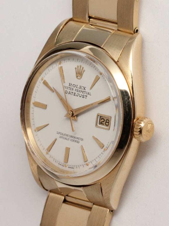 Rolex 14k yellow gold Datejust wristwatch, Ref. 6605, serial 3.8 million, circa 1958, with smooth bezel, antique white dial with applied tapered indexes and tapered hands. With associated 14k yellow gold riveted link Oyster bracelet with deployment