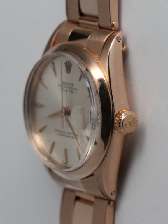 Rolex 18k pink gold midsize Oyster Perpetual Date wristwatch, Ref. 6627, serial 1.2 million, circa 1965. 31mm diameter case with smooth bezel, silvered satin dial with applied markers with tapered hands. Self-winding movement with sweep seconds and