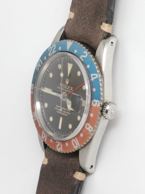 Rolex stainless steel GMT-Master, Ref. 6542, second generation early no-crown-guard model with original metal bezel and faded red and blue aluminum insert. Gorgeous glossy black original inner minute track gilt dial with patinaed luminous indexes,
