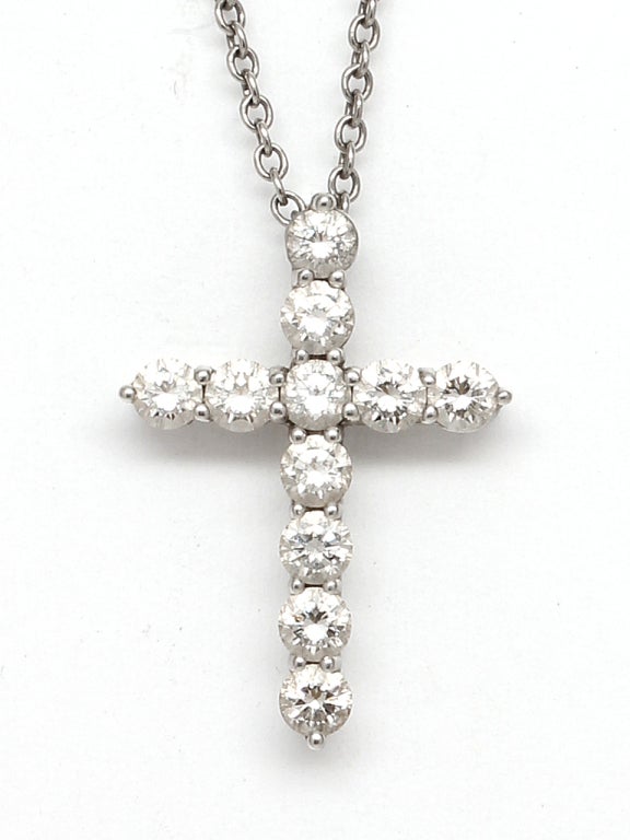 Platinum and Diamond Cross Necklace by Tiffany & Co, circa 1990's.  Set with 12 round brilliant cut diamonds approximately total 0.42 carats on a 16