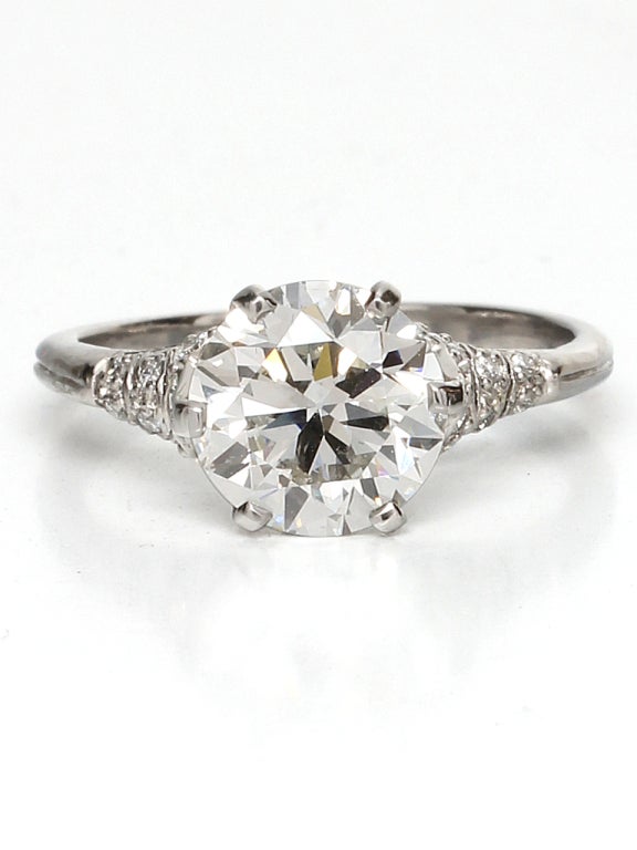 Stunning from every angle and recently price-reduced, this platinum diamond pave engagement ring features an EGL certified 2.36ct G-SI1 round brilliant cut diamond with characteristics of an old European cut. Newly made Edwardian inspired design