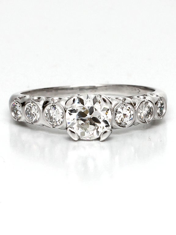 Classic platinum engagement ring. Featuring a 0.72 carat Old European Cut diamond center stone, G color and SI2 clarity. Flanked by 6 diamond side stones in fishtail settings, adding approximately 0.44 carats. Circa 1940's. Ring size 6. 

As a