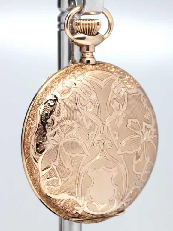 An exceptional condition Waltham 16-size yellow gold filled hunting cased pocket watch with beautifully engraved flowing floral design, with beautiful multicolored enamel dial and Louis XIV hands. 15-jewel manual-wind movement with subsidiary