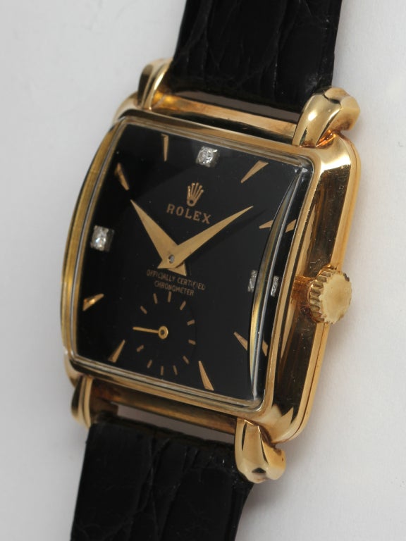 Rolex 18k yellow gold square stepped case wristwatch, 28 X 36mm, with flared and fluted lugs, circa 1950s. Nicley restored glossy black dial with applied diamond and gold indexes. 17-jewel manual-wind calbire 10 1/2 movement with subsididary