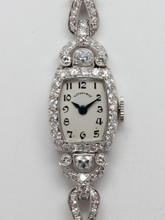 Exceptionally beautiful lady's Hamilton platinum and diamond-set wristwatch, circa 1930s, retailed by Tiffany & Co. Featuring a tonneau shaped case beautifully set with diamonds, hinged diamond set lugs and diamond set cable link style platinum