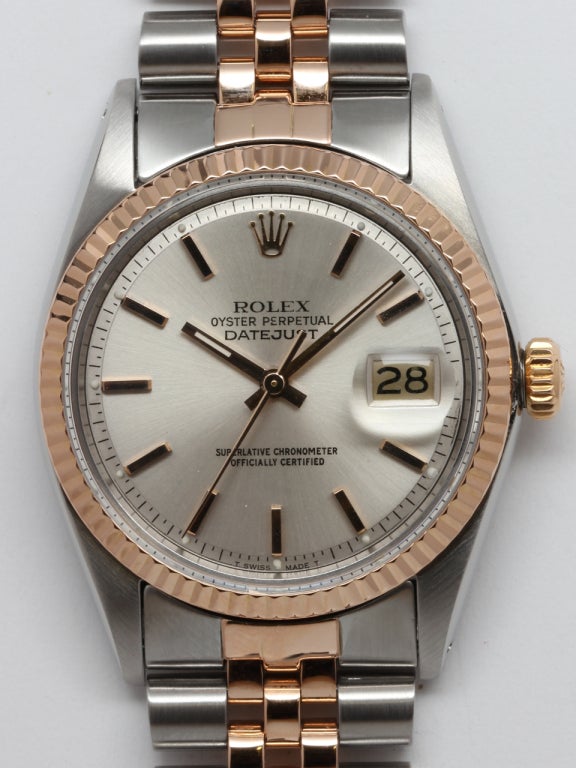 Rolex stainless steel and rose gold full size man's Datejust wristwatch, Ref. 1601, serial number 3.9 million, circa 1975. 36mm diameter case with fluted 14k rose gold bezel and very pleasing silvered satin pie pan dial with applied pink indexes and