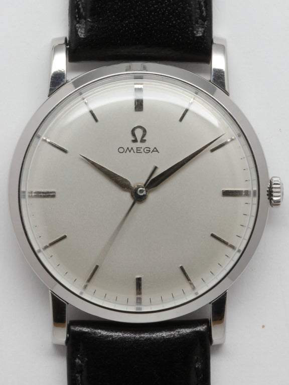 Omega stainless steel 17-jewel manual-wind dress model wristwatch, 32 x 39mm, with straight lugs and snap back case, circa 1960. With original matte silvered satin dial with applied Omega logo and tapered dauphine hands. Calibre 520 movement with