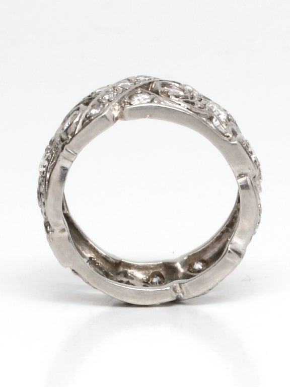 Wide diamond set eternity band in platinum with cut out diamond set hearts crisscross and scrolls design, approximately 1.56 carats total diamond weight. 8mm wide, size 6, circa 1950's

As a special offering for our 1stdibs customers, your