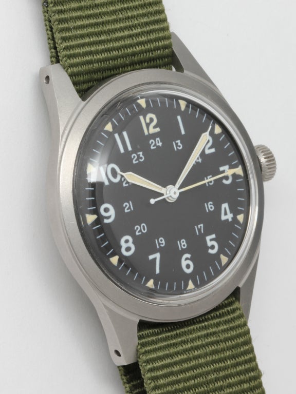 Vietnam-era General Services military-issued Benrus wristwatch with large Arabic and smaller 24 hour indications, luminous dial markers and luminous hour, minute and arrow tipped sweep seconds hand. 33mm diameter stainless steel case with original