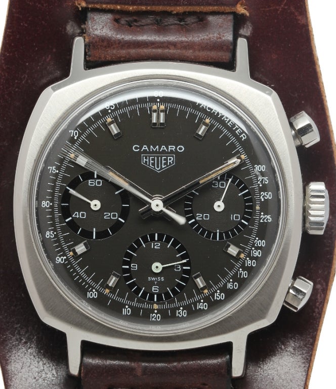 Heuer stainless steel cushion-shaped three-register manual-wind Camaro chronograph wristwatch. Great looking original black dial, turning chocolate color, with applied indexes and luminous baton hands. Signed Heuer crown. Offered on mahogany color