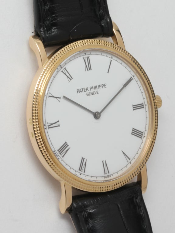 Patek Philippe 18k yellow gold Calatrava wristwatch, Ref. 3520JD, circa 1990s. 31 X 37mm case with hobnail bezel, and screw down case back. Signed Patek Philippe crown, white dial with black Roman numerals and simple blued steel hands. 18-jewel