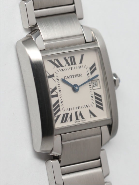 Cartier stainless steel Tank Francaise midsize model 24 X 29mm, white dial, classic black Roman figures. More recent version with date function at 3 O'clock.  Blued steel hands and sapphire cabochon crown. Quartz movement with date. With hidden