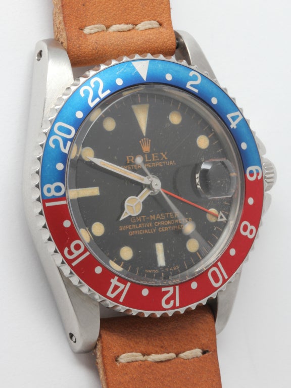 Rolex SS GMT ref 1675 serial # 696,xxx circa 1961 with original crazed gilt dial. Pleasing example with faded red and blue pepsi bezel, patin'ad luminous indexes and matching hands, red mini 24 hour hand. Self winding calibre 1560 movement with