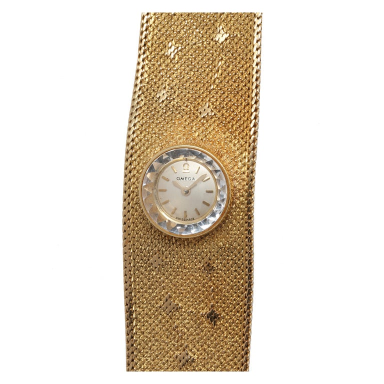 Omega lady's 18k yellow gold wide mesh bracelet dress watch with sun, moon, stars, and planets design circa 1960's. . Beautiful condition and design. Original silvered satin dial with applied indexes.17 jewel manual wind back wind movement.
