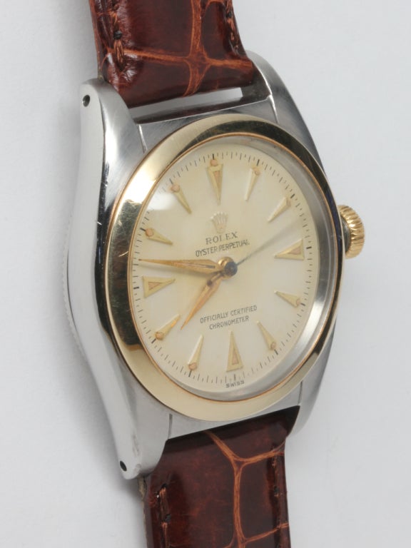 Rolex stainless steel and yellow gold Oyster Perpetual Bubbleback wristwatch, circa 1948. 32mm diameter tonneau shaped case with screw down period crown and screw down case back. Gorgeous condition original silvered dial with raised triangular
