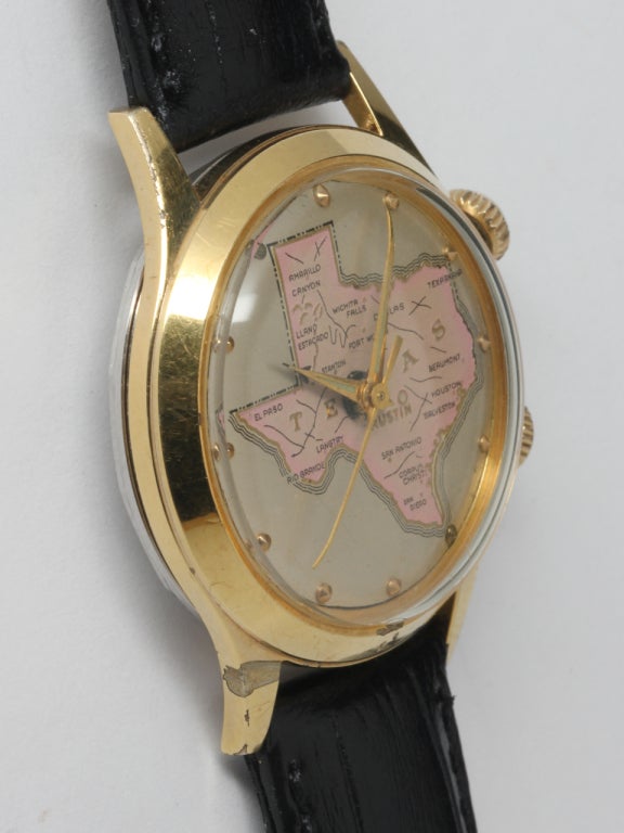 Swiss gilt metal alarm wristwatch with map of Texas, circa 1970s. 17-jewel manual-wind watch featuring colorful map of state of Texas showing terrain and major cities. Gilt metal top and stainless steel case back. Great looking and fully