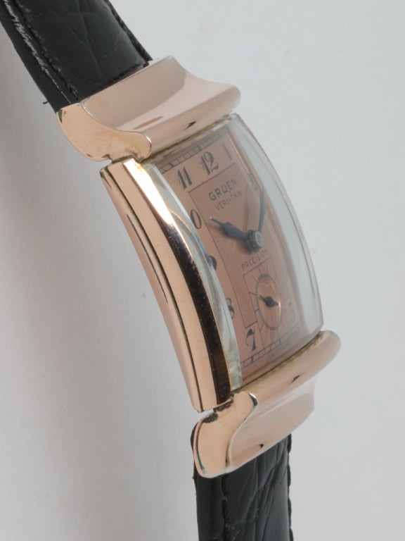 Gruen rose gold filled Veri-Thin rectangular wristwatch, circa 1940s. Rectangular case with curved back and beautiful original two-tone salmon dial with printed Arabic figures and blued steel hands. Calibre 430 manual-wind movement with subsidiary