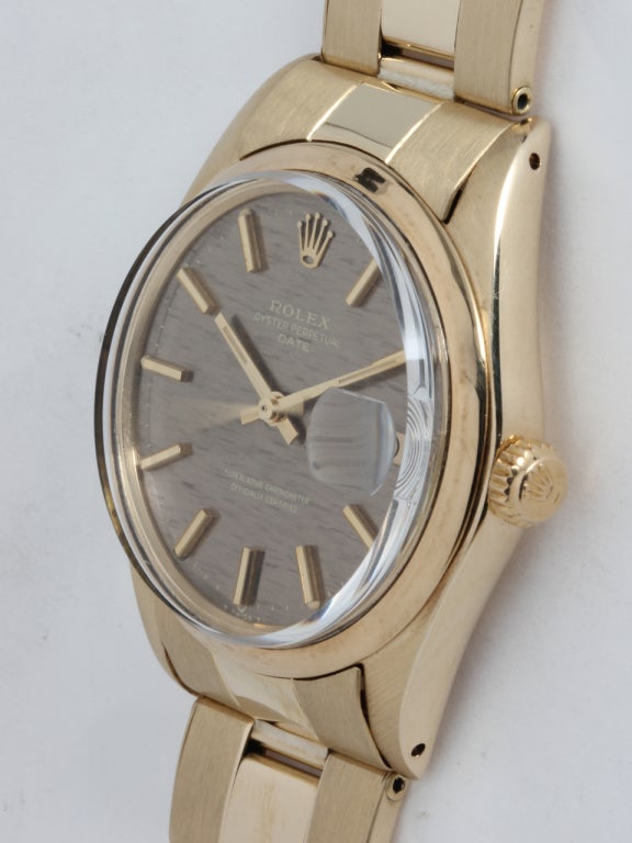 Rolex 14k yellow gold Oyster Perpetual Date wristwatch, Ref. 1501, serial number 2.6 million, circa 1970. 34mm case with smooth bezel and acrylic crystal, very interesting light bronze finely textured dial with applied indexes and baton hands.