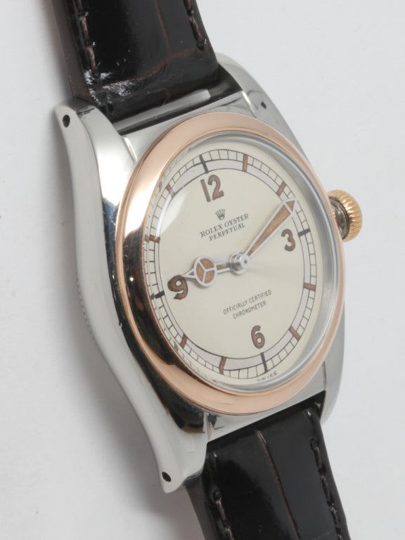 Rolex stainless steel and rose gold Bubbleback wristwatch, Ref. 5010, serial number 62,XXX, circa 1948. Beautiful condition example, 32mm diameter tonneau case with screw down caseback and period-style screw down crown. Beautifully restored silvered