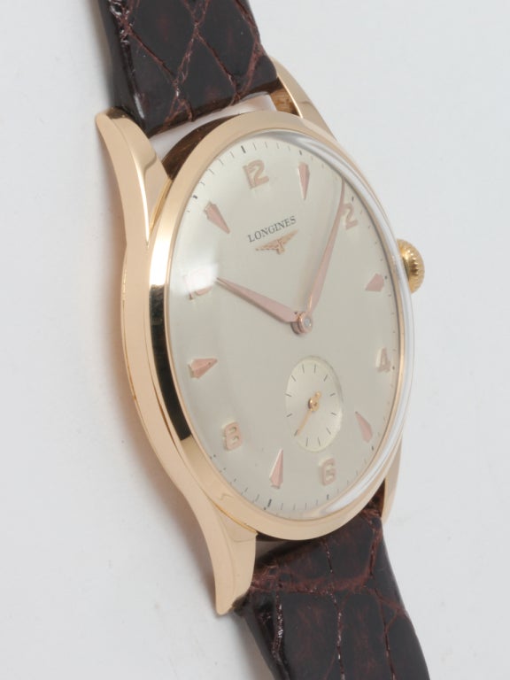 Longines 18k yellow gold oversized wristwatch, circa 1950s, Ref. 62479. 37 X 43mm case with extended lugs and beautiful original silvered satin dial with gold raised indexes and tapered alpha hands. 17-jewel manual-wind calbire 27M movement with